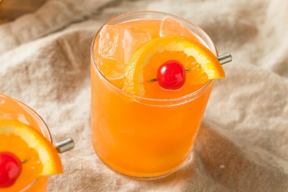 Amaretto Stone Sour Cocktail with Orange and Cherry Garnish