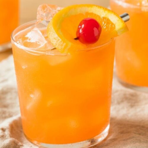 Glass of Amaretto Stone Sour Cocktail Recipe Includes Orange and Cherry