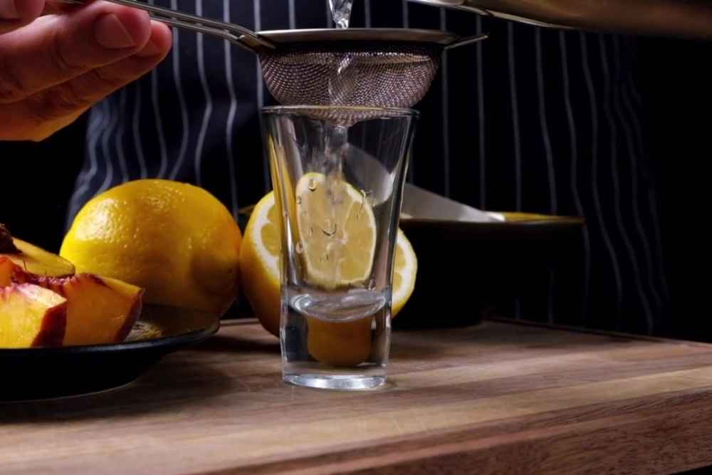 Straining White Tea Drink into Shot Glass