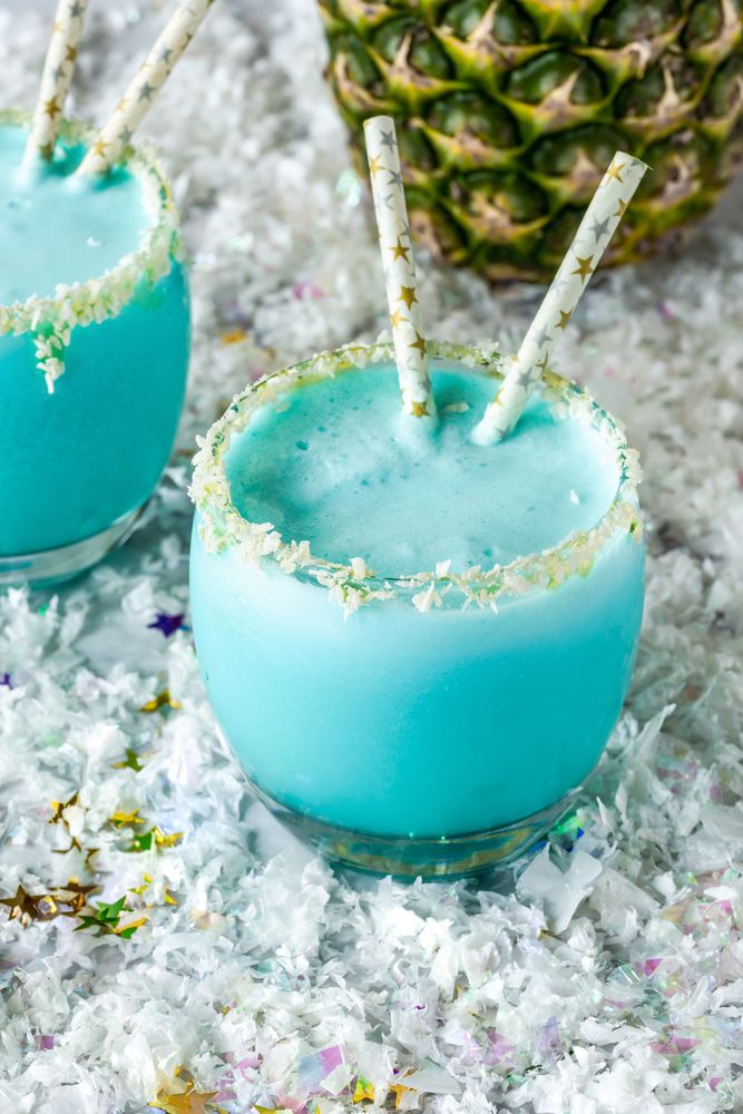 Blue Jack Frost Cocktail with 2 Straws on Coconut