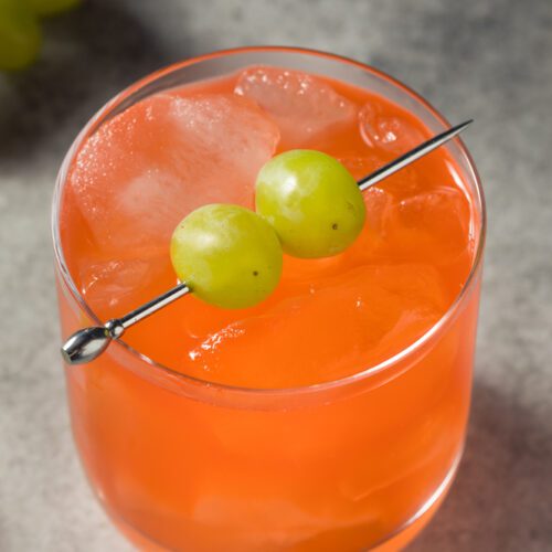 Closeup of Enzoni Cocktail Drink with Grape Garnish