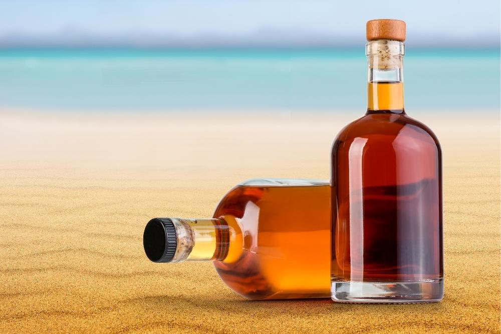 Bottles of Rum Unopened on Beach