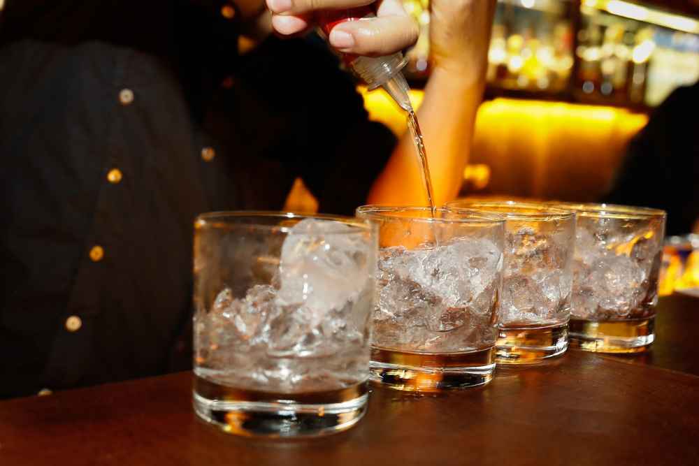 Bartender Pouring Vodka in Glasses