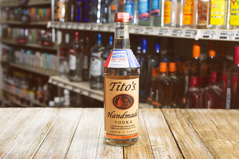 Bottle of Tito's Vodka on Wood Shelf in Liquor Store