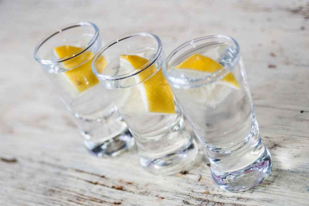 Three Shots of Vodka with Lemon Wedges
