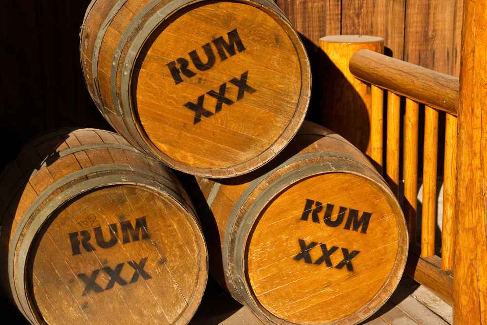 How to Store Rum Bottles - Rum in Front of Wood Barrel