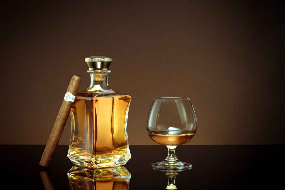 Dark Rum Stored in Decanter Bottle with Cigar and Glass