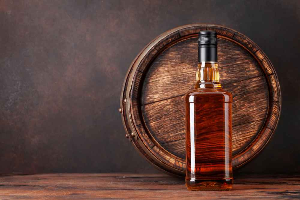 How to Store Rum Bottles - Rum in Front of Wood Barrel