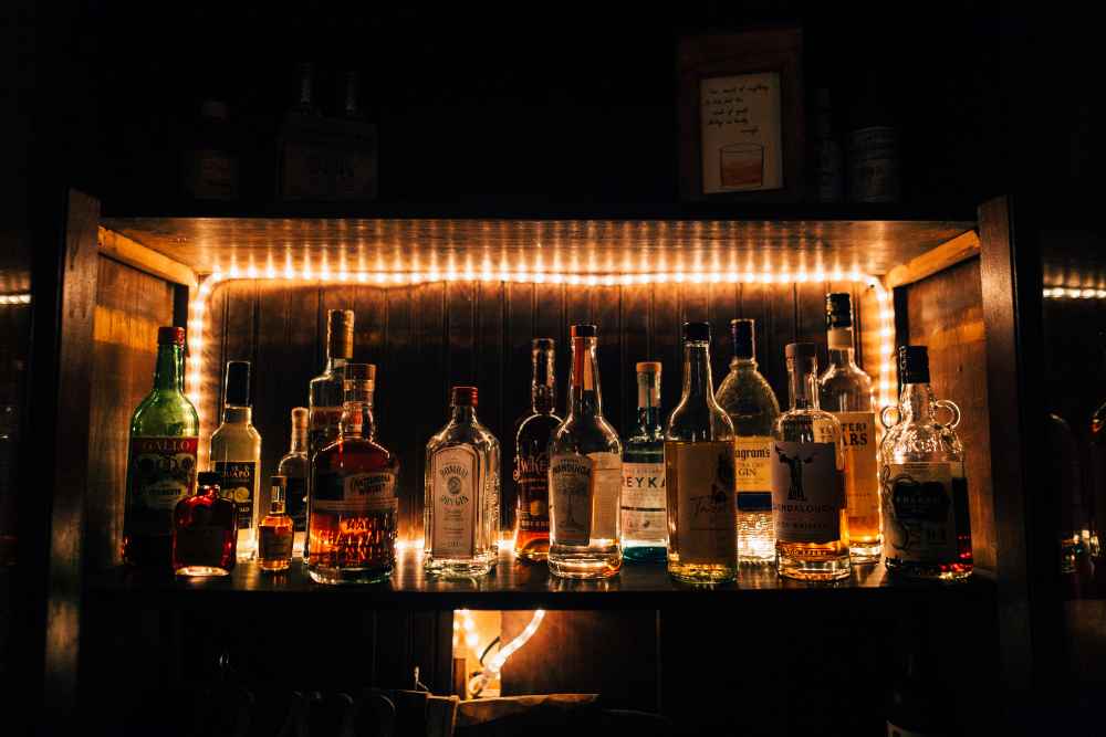 Liquor Bottles on Bar Shelf with Lights