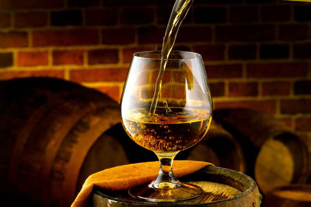 Pouring Martell VS Cognac on Barrel